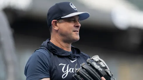 Manager Aaron Boone #17 of the New York Yankees plays catch before a game against the Chicago White Sox at Guaranteed Rate Field.