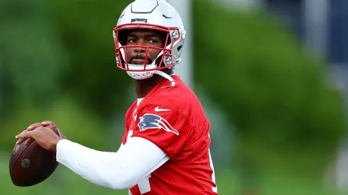 Jacoby Brissett #14 of the New England Patriots makes a pass during the New England Patriots OTA Offseason Workout on May 29, 2024 in Foxborough, Massachusetts.