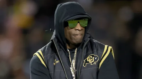  Head coach Deion Sanders of the Colorado Buffaloes walks on the field during pregame against the Stanford Cardinal at Folsom Field on October 13, 2023 in Boulder, Colorado. 
