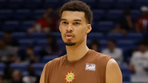 Victor Wembanyama #1 of the San Antonio Spurs participates in warmups
