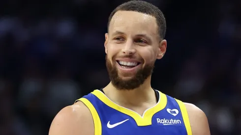 Stephen Curry #30 of the Golden State Warriors jokes with Sacramento Kings head coach Mike Brown in the first quarter during the Play-In Tournament at Golden 1 Center on April 16, 2024 in Sacramento, California. 
