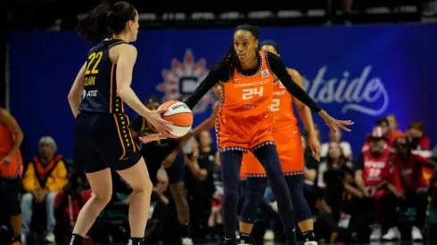 DeWanna Bonner #24 of the Connecticut Sun defends against Caitlin Clark #22 of the Indiana Fever
