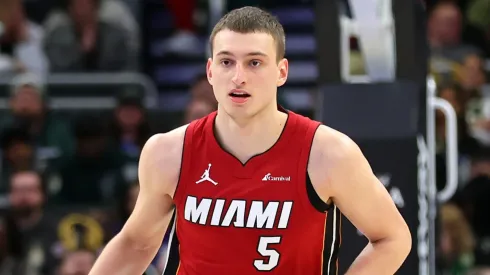 Nikola Jovic #5 of the Miami Heat handles the ball during a game against the Milwaukee Bucks at Fiserv Forum.