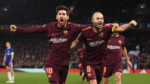Lionel Messi of Barcelona celebrates his equaliser with team mate Andres Iniesta during the UEFA Champions League Round of 16 First Leg match between Chelsea FC and FC Barcelona