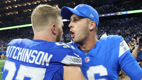 Jared Goff #16 and Aidan Hutchinson #97 of the Detroit Lions celebrate defeating the Los Angeles Rams 26-20 in overtime at Ford Field on September 08, 2024 in Detroit, Michigan.
