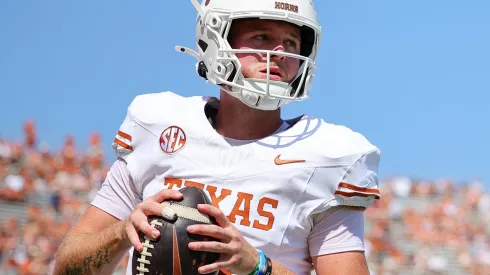 Quinn Ewers #3 of the Texas Longhorns warms up prior to a game against the Oklahoma Sooners at Cotton Bowl Stadium on October 12, 2024 in Dallas, Texas.
