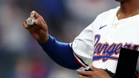  Jose Leclerc #25 of the Texas Rangers shows his World Series ring prior to a game against the Chicago Cubs at Globe Life Field on March 30, 2024 in Arlington, Texas.
