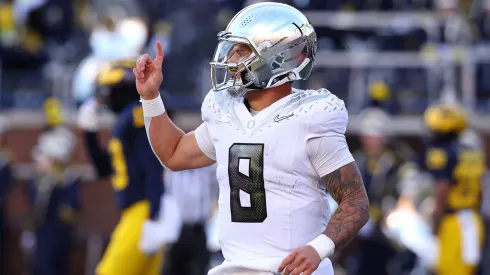 Dillon Gabriel #8 of the Oregon Ducks celebrates after running the ball for a touchdown during the second quarter against the Michigan Wolverines at Michigan Stadium on November 02, 2024 in Ann Arbor, Michigan.
