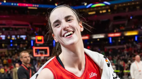 Caitlin Clark of Indiana Fever is presented the game ball after becoming the first rookie to score a triple double against the New York Liberty
