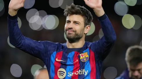  Gerard Pique of FC Barcelona waves to fans as they take part in a lap of honour
