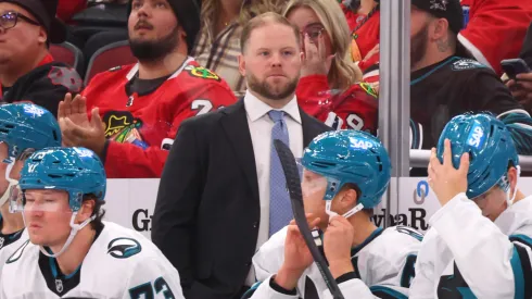  San Jose Sharks head coach Ryan Warsofsky stands behind his team on the bench during their game against the St. Louis Blues at SAP Center on October 10, 2024 in San Jose, California.
