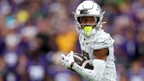 Tez Johnson #15 of the Oregon Ducks carries the ball against the Washington Huskies during the third quarter at Husky Stadium on October 14, 2023 in Seattle, Washington. 
