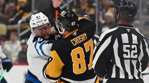 Sidney Crosby #87 of the Pittsburgh Penguins fights Kyle Connor #81 of the Winnipeg Jets in the third period during the game at PPG PAINTS Arena on November 22, 2024 in Pittsburgh, Pennsylvania.
