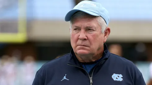 Head coach Mack Brown of the North Carolina Tar Heels watches his team warm up before their game against the Florida State Seminoles at Kenan Memorial Stadium on October 09, 2021 in Chapel Hill, North Carolina.