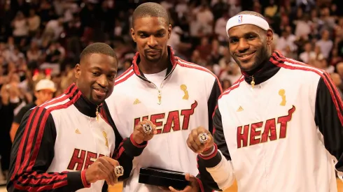 (L) Dwyane Wade #3 of the Miami Heat, (C) Chris Bosh #1 of the Miami Heat and (R) LeBron James #6 of the Miami Heat pose with their 2012 NBA Championship rings prior to the game against the Boston Celtics at American Airlines Arena on October 30, 2012 in Miami, Florida. 
