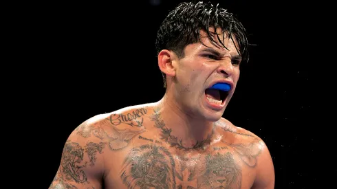 Ryan Garcia (white trunks) reacts against Devin Haney (gray trunks) during their WBC Super Lightweight title bout at Barclays Center on April 20, 2024 in New York City. 
