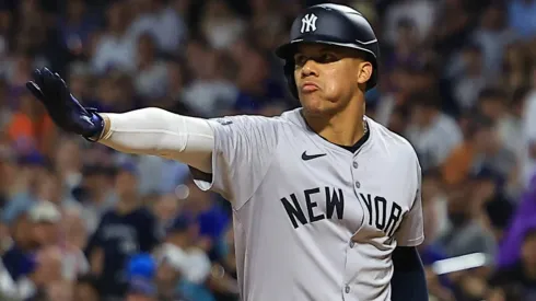 Juan Soto #22 of the New York Yankees is signaling to teammate Austin Wells not to advance on a pitch during the eighth inning of the baseball game against the New York Mets.
