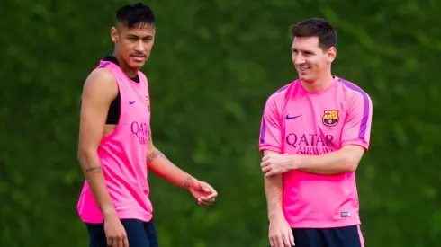 Neymar (L) and Lionel Messi (R) look on during a FC Barcelona training session at Ciutat Esportiva on August 17, 2014 in Barcelona, Spain.
