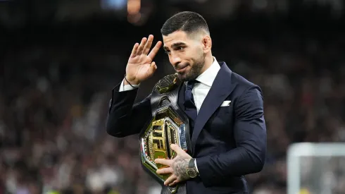 Ilia Topuria , UFC Featherweight Champion, is seen with his belt on the pitch prior to the LaLiga EA Sports match between Real Madrid CF and Sevilla FC