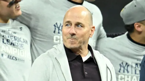New York Yankees general manager Brian Cashman looks on during the trophy ceremony after the Yankees beat the Cleveland Guardians 5-2 in 10 innings in Game Five of the American League Championship Series at Progressive Field on October 19, 2024 in Cleveland, Ohio.