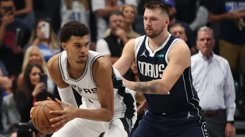 Victor Wembanyama #1 of the San Antonio Spurs is defended by Luka Doncic #77 of the Dallas Mavericks during the first quarter of the game at American Airlines Center on October 24, 2024 in Dallas, Texas. 
