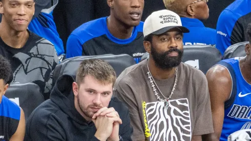 Dallas Mavericks Luka Doncic 77 and Kyrie Irving 11 watch from the bench during an NBA
