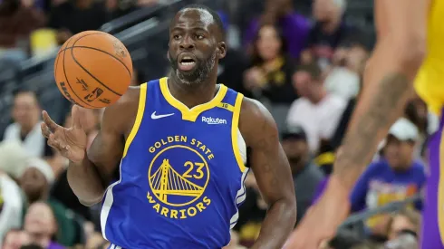 Draymond Green #23 of the Golden State Warriors brings the ball up the court against the Los Angeles Lakers in the first quarter of their preseason game.
