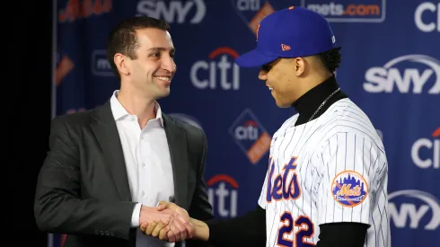 David Stearns, the president of baseball operations for the New York Mets fits Juan Soto with his New York Mets jersey, during his introductory press conference at Citi Field on December 12, 2024 in New York City.