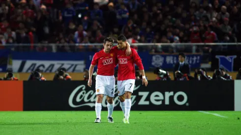 Cristiano Ronaldo and Gary Neville talking in a Manchester United match.
