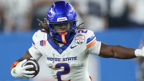 Ashton Jeanty #2 of the Boise State Broncos runs the ball against Tony Rojas #13 of the Penn State Nittany Lions during the first half in the 2024 Vrbo Fiesta Bowl at State Farm Stadium on December 31, 2024 in Glendale, Arizona.
