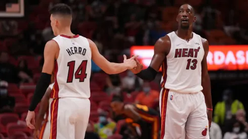 Tyler Herro #14 and Bam Adebayo #13 of the Miami Heat slaps hands in the second quarter against the Atlanta Hawks in preseason action at FTX Arena on October 04, 2021 in Miami, Florida. 
