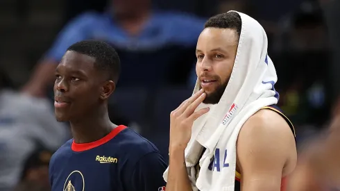 Dennis Schroder #17 of the Brooklyn Nets and Stephen Curry #30 of the Golden State Warriors look on during the game
