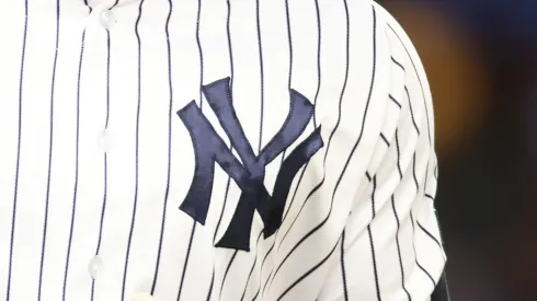 A close-up of Aaron Judge's #99 jersey of the New York Yankees as he points to the dugout after hitting his third home run of the game against the Washington Nationals at Yankee Stadium.
