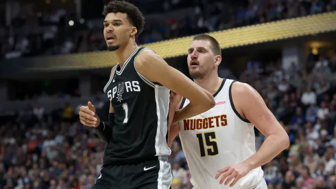 Victor Wembanyama #1 of the San Antonio Spurs is guarded by Nikola Jokic #15 of the Denver Nuggets in the fourth quarter at Ball Arena.
