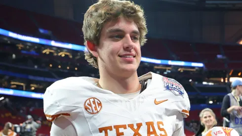 Arch Manning #16 of the Texas Longhorns poses for a photo after defeating the Arizona State Sun Devils 39-31 during the second overtime in the Chick-fil-A Peach Bowl at Mercedes-Benz Stadium on January 01, 2025 in Atlanta, Georgia.
