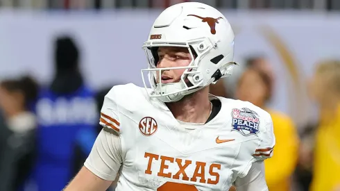 Quinn Ewers #3 of the Texas Longhorns reacts after throwing a pass for a touchdown during the first overtime against the Arizona State Sun Devils in the Chick-fil-A Peach Bowl at Mercedes-Benz Stadium on January 01, 2025 in Atlanta, Georgia.
