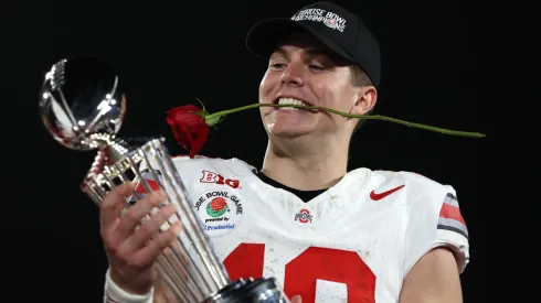 Will Howard #18 of the Ohio State Buckeyes holds the Leishman Trophy after defeating the Oregon Ducks 41-21 in the Rose Bowl Game Presented by Prudential at Rose Bowl Stadium on January 01, 2025 in Pasadena, California. 
