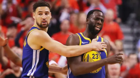 Klay Thompson #11 and Draymond Green #23 of the Golden State Warriors react after a foul call against the Toronto Raptors
