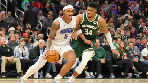 Paolo Banchero #5 of the Orlando Magic is defended by Giannis Antetokounmpo #34 of the Milwaukee Bucks during a game at Fiserv Forum on December 21, 2023 in Milwaukee, Wisconsin.