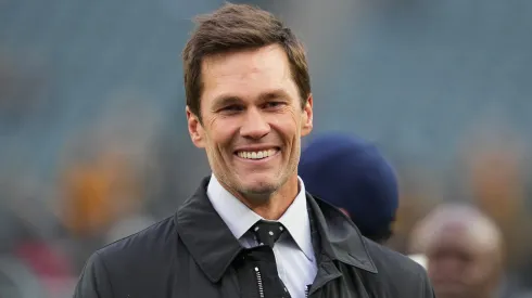 Tom Brady looks on from the field prior to an NFL football game between the Pittsburgh Steelers and the Philadelphia Eagles at Lincoln Financial Field on December 15, 2024 in Philadelphia, Pennsylvania.