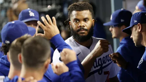 Teammates greet Kenley Jansen #74 of the Los Angeles Dodgers in the dugout after the top of the ninth inning against the St. Louis Cardinals during the National League Wild Card Game at Dodger Stadium on October 06, 2021 in Los Angeles, California.