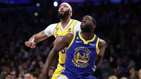 Anthony Davis #3 of the Los Angeles Lakers and Draymond Green #23 of the Golden State Warriors battle for a rebound.