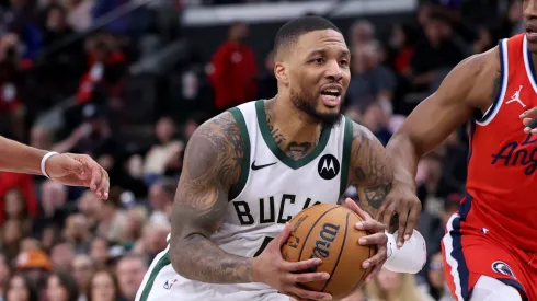 Damian Lillard #0 of the Milwaukee Bucks drives to the basket between Terance Mann #14 ad Nicolas Batum #33 of the LA Clippers