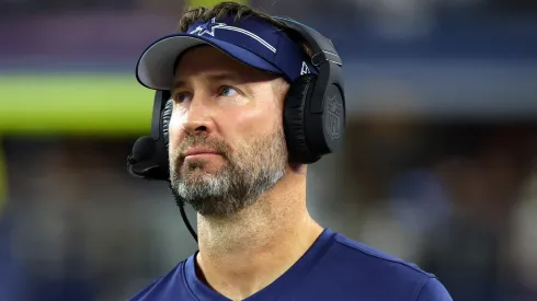 Dallas Cowboys head coach Brian Schottenheimer during his time as offensive coordinator watches from the sidelines in a preseason game against the Las Vegas Raiders at AT&T Stadium on August 26, 2023 in Arlington, Texas.