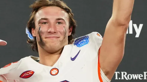 Dabo Swinney, Cade Klubnik #2 and the Clemson Tigers celebrate after winning the 2024 ACC Football Championship at Bank of America Stadium on December 07, 2024 in Charlotte, North Carolina.