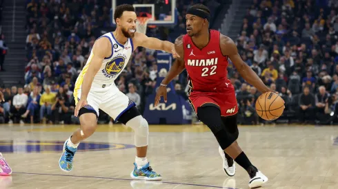 Jimmy Butler #22 of the Miami Heat is guarded by Stephen Curry #30 of the Golden State Warriors at Chase Center on October 27, 2022 in San Francisco, California.