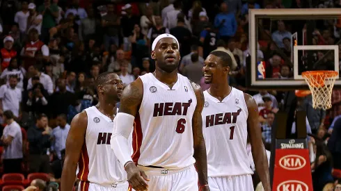 Dwyane Wade #3, LeBron James #6 and Chris Bosh #1 of the Miami Heat look on during a game against the Milwaukee Bucks