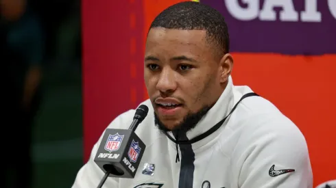 Philadelphia Eagles running back Saquon Barkley is surrounded by cameras on the field inside the Caesars Superdome during the Super Bowl Opening Night on February 3, 2025 in New Orleans, Louisiana. The Philadelphia Eagles and Kansas City Chiefs were made available for interviews during an energetic, New Orleans-themed event ahead of next Sunday's Super Bowl LIX.