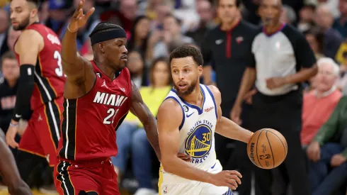 Stephen Curry #30 of the Golden State Warriors is guarded by Jimmy Butler #22 of the Miami Heat.