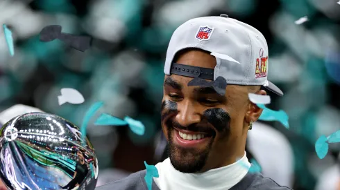 Jalen Hurts #1 of the Philadelphia Eagles celebrates with the Vince Lombardi Trophy after beating the Kansas City Chiefs 40-22 to win Super Bowl LIX
